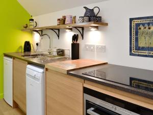 a kitchen with a sink and a counter top at The Hayloft in Blitterlees