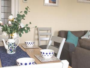 a living room with a table with blue and white cups at Sea Views in Filey