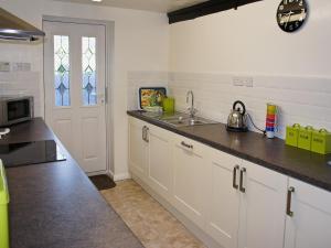 a kitchen with a sink and a counter top at Kingfisher - 30788 in Swimbridge