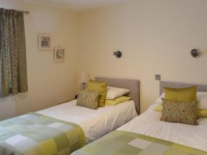 two beds in a small room with two at The Stable in Burscough
