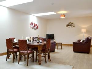 a living room with a table and chairs and a couch at The Parlour - Op4 in Carmarthen