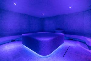 a purple room with a bed in the middle at HVOYA Apart-Hotel & SPA in Bukovel