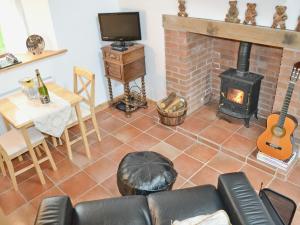a living room with a couch and a fireplace at Angel Barn in Farden