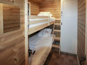 a bedroom with two bunk beds in a log cabin at Treehouse Cabin in Westward