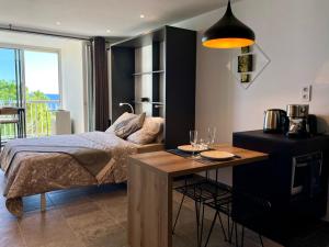 a bedroom with a bed and a table with wine glasses at Vacances paradisiaques, Plage Cannes boccacabana, studio in Cannes