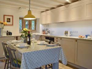 a kitchen with a table with a table cloth on it at Prospect Cottage in Kettlewell