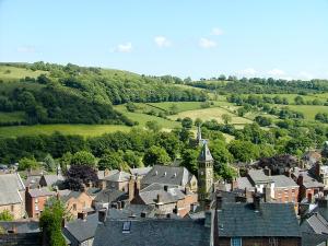an aerial view of a town with a clock tower at The Wee House On The Hill in Wirksworth