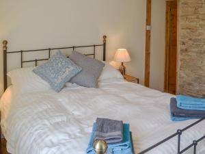 a bedroom with a white bed with towels on it at Duke Street in Lostwithiel