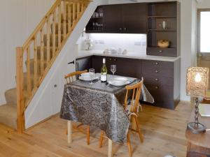 a dining room with a table with chairs and a staircase at Duke Street in Lostwithiel