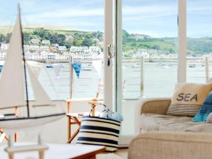 a living room with a view of the water and boats at Shorewaters in Appledore