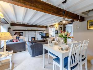 a living room with a table and chairs at Mill Cottage in Bampton