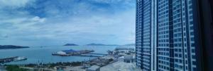 a view of the water from a tall building at Kota Kinabalu Jesselton Quay Seaview with washing machine in Kota Kinabalu