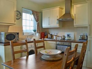 a kitchen with a wooden table with a bowl on it at Seaview in Garlieston