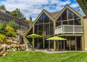 a house with two green umbrellas in a yard at Skiers Lodge in Park City