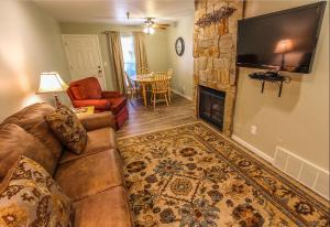 a living room with a couch and a fireplace at Skiers Lodge in Park City