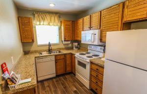 a kitchen with wooden cabinets and a white refrigerator at Skiers Lodge in Park City