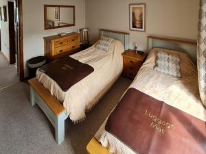 a bedroom with two beds and a mirror at Herons View - 28279 in Brundall