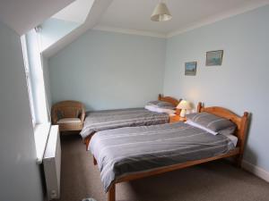 two twin beds in a room with a window at Ty Gwyn - Hw7322 in Haverfordwest