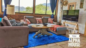 a living room with a couch and a table at Alpha House in Vilcabamba