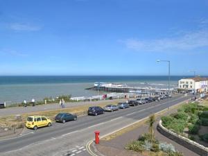a highway with cars parked on the side of a beach at Bounty in Cromer