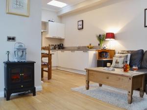 a living room with a coffee table and a stove at Castle Dairy - 27901 in Ceres