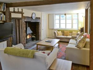 a living room with couches and a fire place at Varley House in Saxmundham