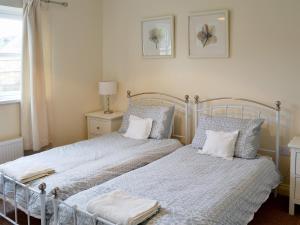 - une chambre avec 2 lits avec des oreillers et une fenêtre dans l'établissement Ryandale, à Longhirst