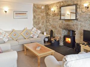 a living room with a couch and a fireplace at Bishop Rock - Grl in Trevilley