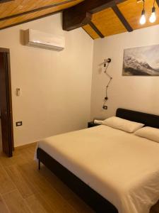 1 dormitorio con 1 cama y una cámara en la pared en 21House - Appartamento 2, en Busto Arsizio