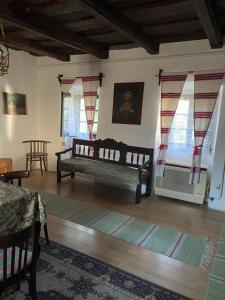 a living room with a bench in a room with windows at Vén Diófa Kúria in Balaton