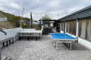 a patio with a ping pong table and benches at Guest House with Hot Tub 11 Mi to Downtown Phoenix in Phoenix