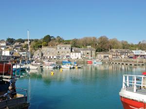 a group of boats are docked in a harbor at Little Tamarisk in Padstow