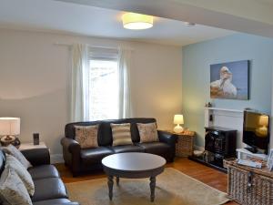 a living room with a couch and a table at Chesnut Cottage - 27524 in Sewerby