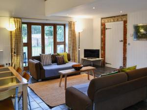 a living room with a couch and a table at The Granary in Oxborough