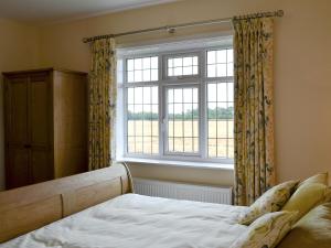 a bedroom with a bed and a window at Tudor House in Eastrington
