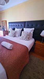 a bedroom with two beds and a blue headboard at DOWNTOWN-Guest House in Olhão