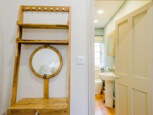 a bathroom with a mirror and a sink at Rectory Cottage in Blankney