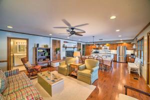 a living room and kitchen with a ceiling fan at Lakefront Harrison Home with Sunroom, Deck, and Dock! in Ooltewah