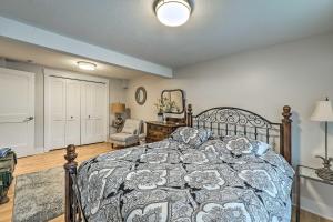 a bedroom with a bed with a blue and white comforter at Downtown Grand Haven Apt Less Than 1 Mi to Lake Michigan in Grand Haven