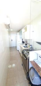 a large kitchen with a stove and a sink at Perfect views best location in Rio de Janeiro +22 photos