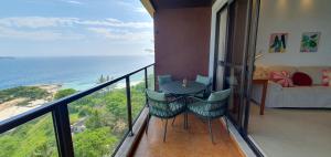 a balcony with a table and chairs and the ocean at Perfect views best location in Rio de Janeiro