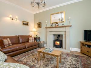 a living room with a couch and a fireplace at The Laburnums in Askham