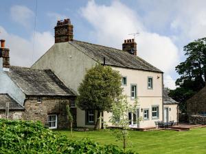 a white house with a chimney on top of it at The Laburnums in Askham