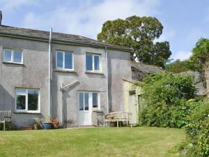 una vista exterior de una casa con patio en Winscott Cottage en Pyworthy