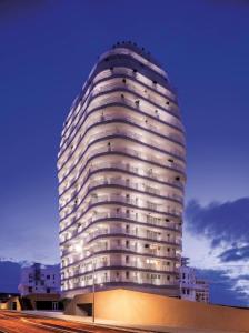 a tall white building with lights on it at Appartement Anfa Park casa finance City CFC in Casablanca