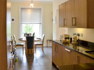 a kitchen with a table and a dining room at Carnethic House - One Acre View in Fowey