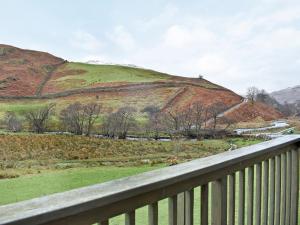 a view of a hill from a balcony at Howegrain Lodge in Glenridding