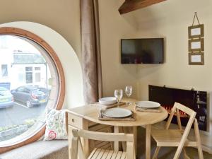 a dining room with a table and a window at The Round Window in Bowness-on-Windermere