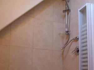 a shower with a shower head in a bathroom at The Round Window in Bowness-on-Windermere