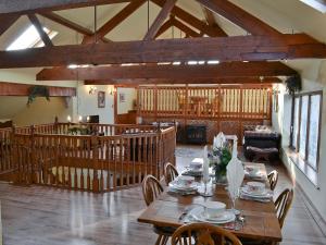 a dining room with a wooden table and chairs at Pheasant Roost in Swanton Morley